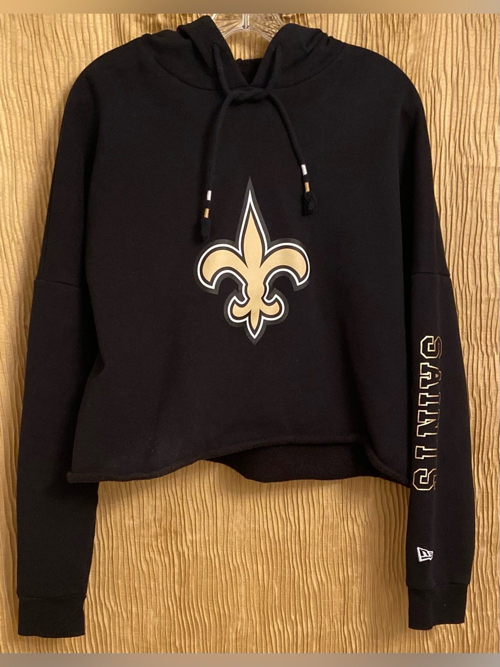 New Orleans Saints Black Cropped Hoodie with Gold Fleur-de-Lis Graphic